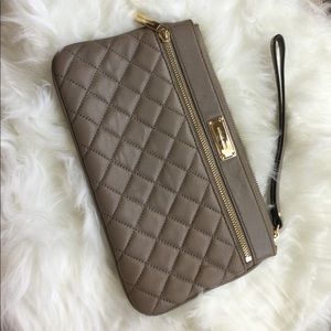 MK tan wristlet, has 6 compartment to fit credit card in front part.